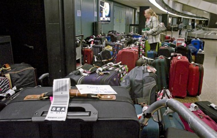 Jeannie Smith of Utah looks for her bag at the SouthWest Airlines baggage claim in SeaTac Airport Tuesday, Nov. 23, 2010. Monday's snows caused many passengers and their bags to arrive separately. Activities at the airport appear normal today. (AP Photo/ The News Tribune, Peter Haley)